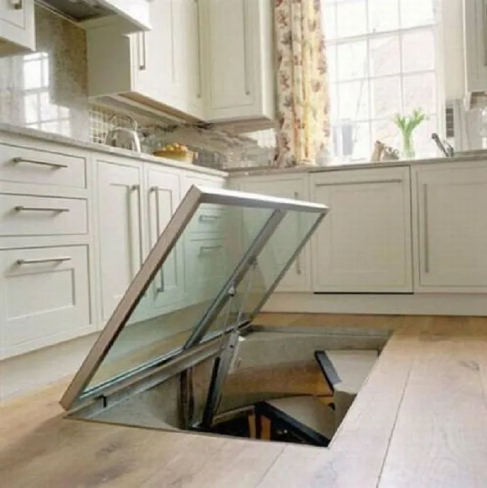 THE GUY MADE A SECRET WINDOW ON THE FLOOR IN THE KITCHEN