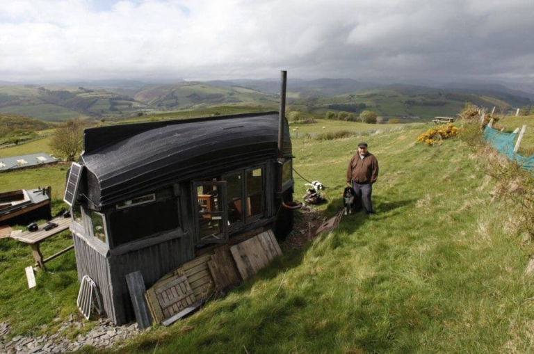 Old and Dusty Boat Converted into a Perfect Camping Illusion Under A Wooden Roof