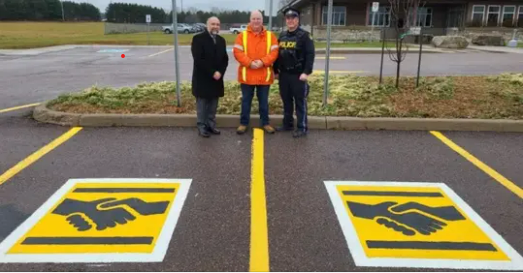 Here’s what a handshake symbol on a parking space means